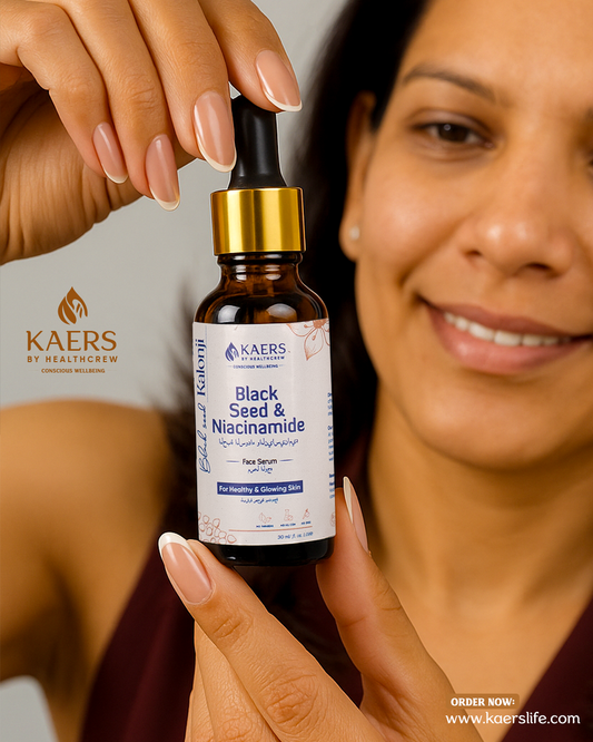 KAERS Black Seed & Niacinamide serum bottle held by a person with a blurred background