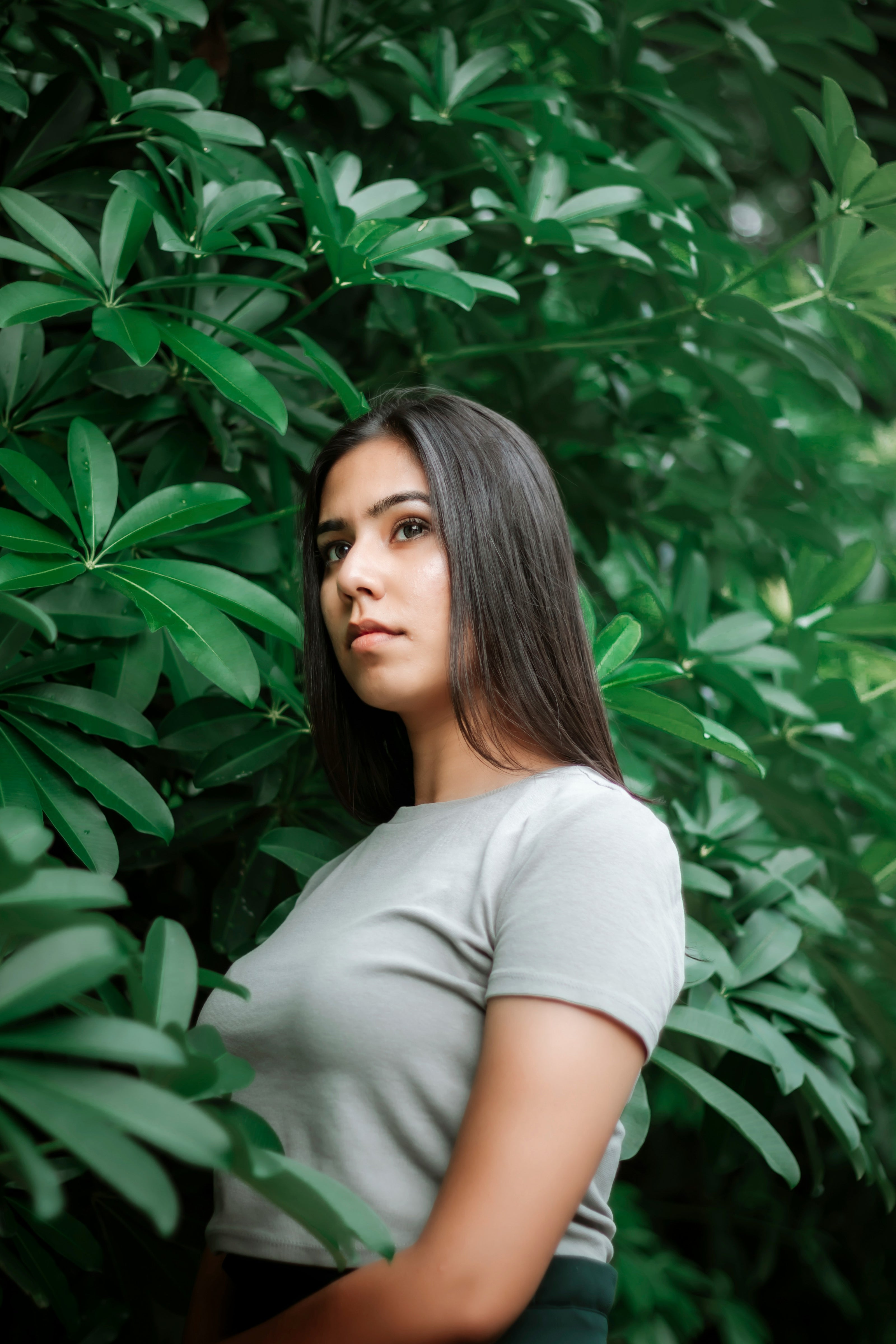 kaers Woman with good hair standing among green foliage