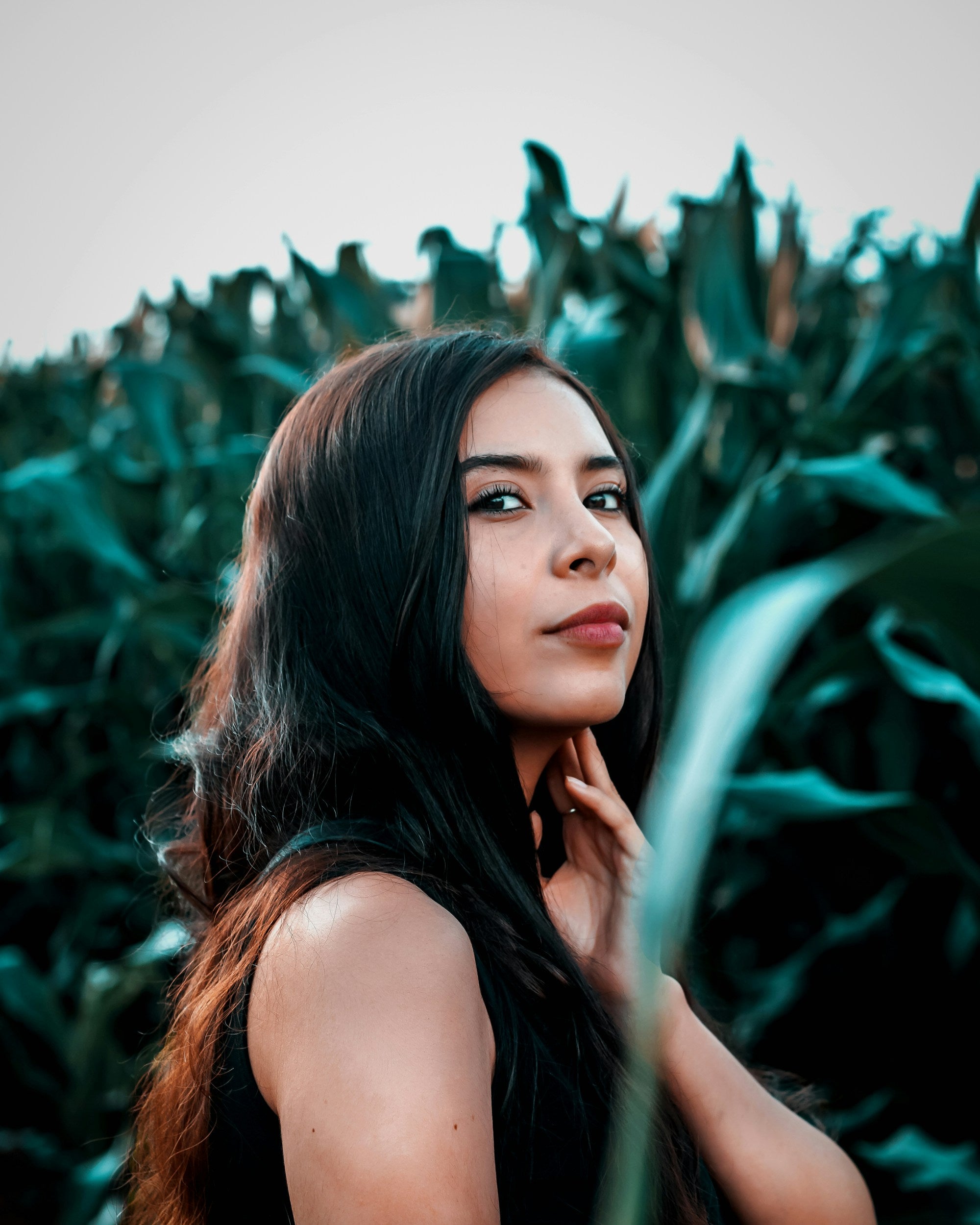 Kaers Woman standing in front of a field of green plants